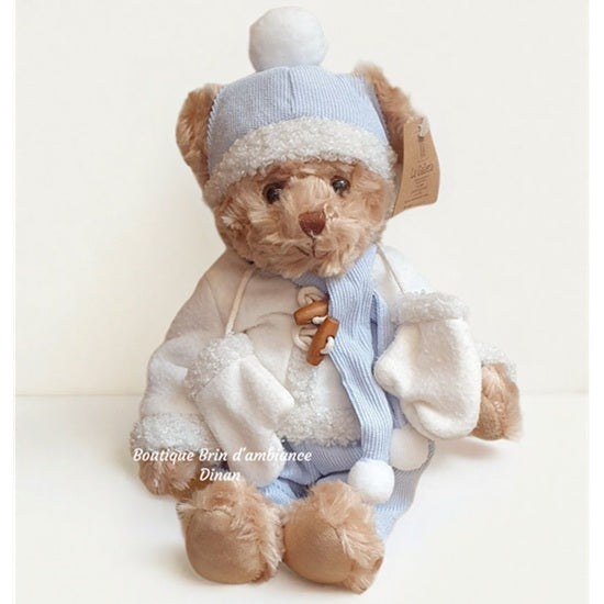 Ourson en peluche en costume bleu et blanc d'hiver