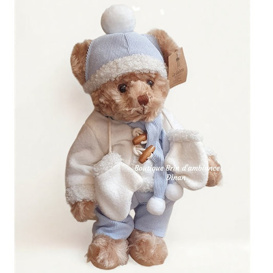 Ourson en peluche en costume bleu et blanc d'hiver
