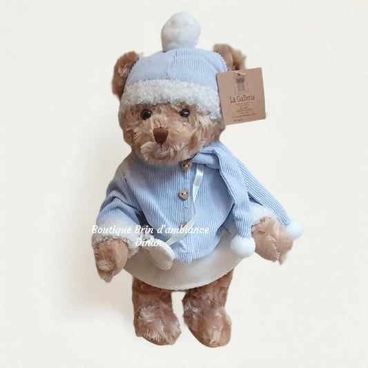 Oursonne en peluche en robe bleu et blanc d'hiver
